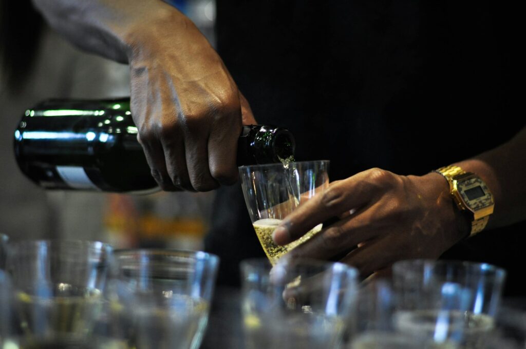 person holding clear drinking glass Bottle Service
