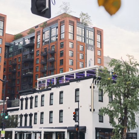 city corner in Washington dc with a white building in front a of red building